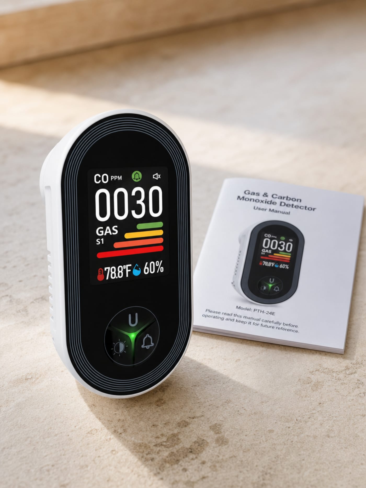 VIGILOX 4-in-1 CO monitor packshot on a kitchen countertop, color IPS display showing live CO, temperature and humidity readings, user manual alongside