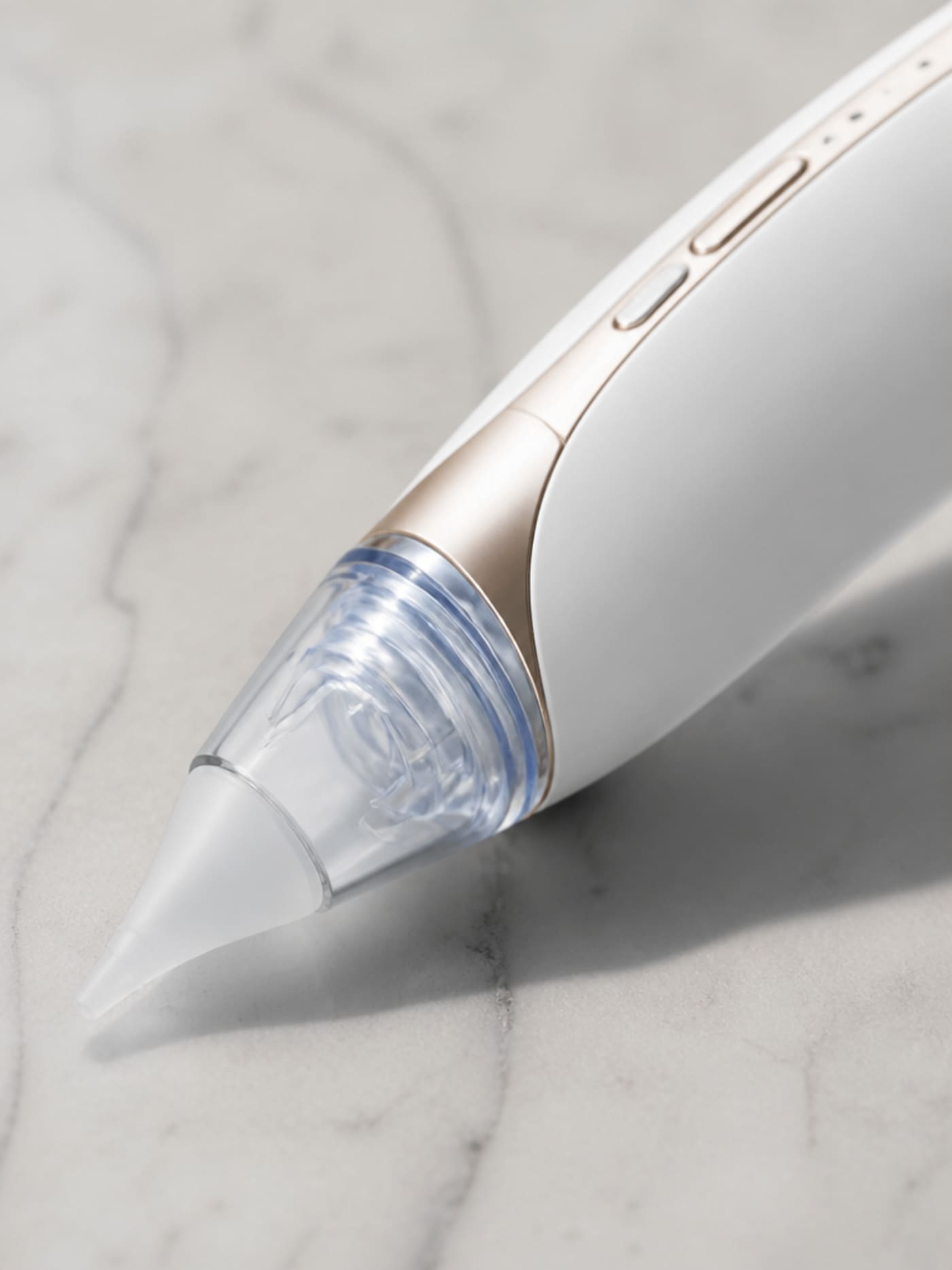 Close macro detail photograph of Vacurio device showing matte finish texture, silicone tip translucency, and button detail