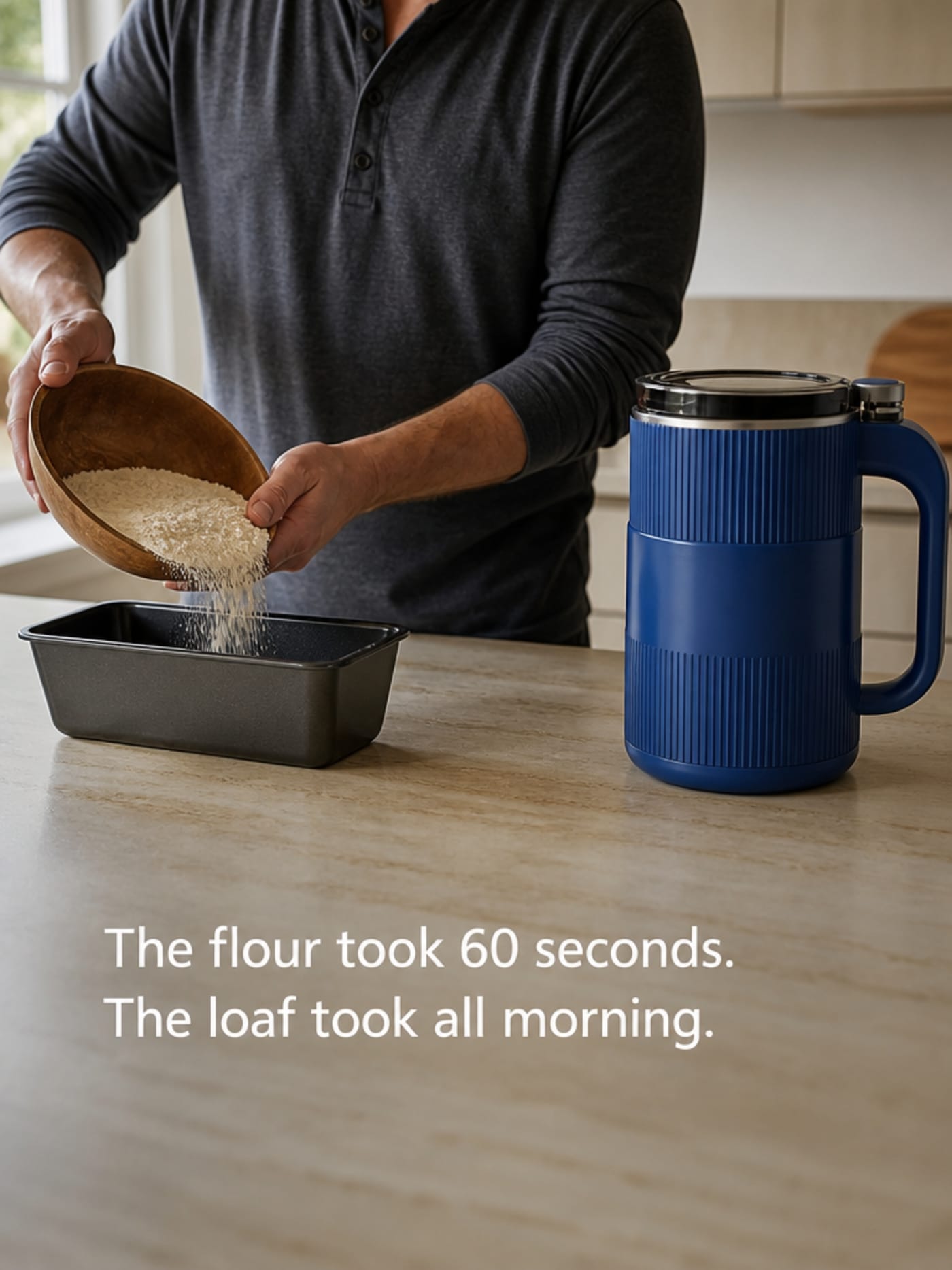 Home baker pouring fresh-milled flour from a wooden bowl into a loaf pan, Grainbloom mill visible on the counter