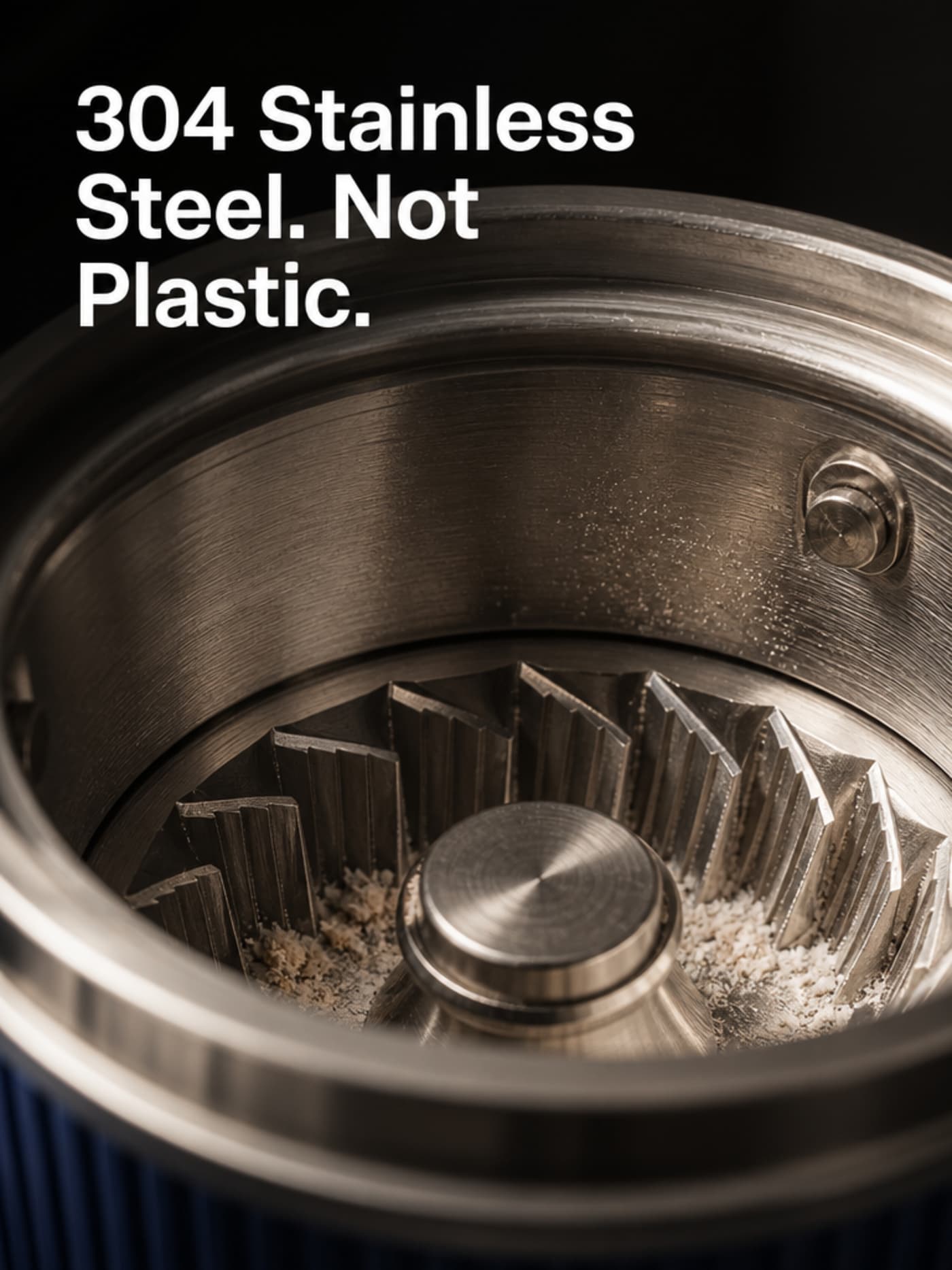 Macro photograph of Grainbloom 304 stainless steel grinding chamber interior showing real metal texture