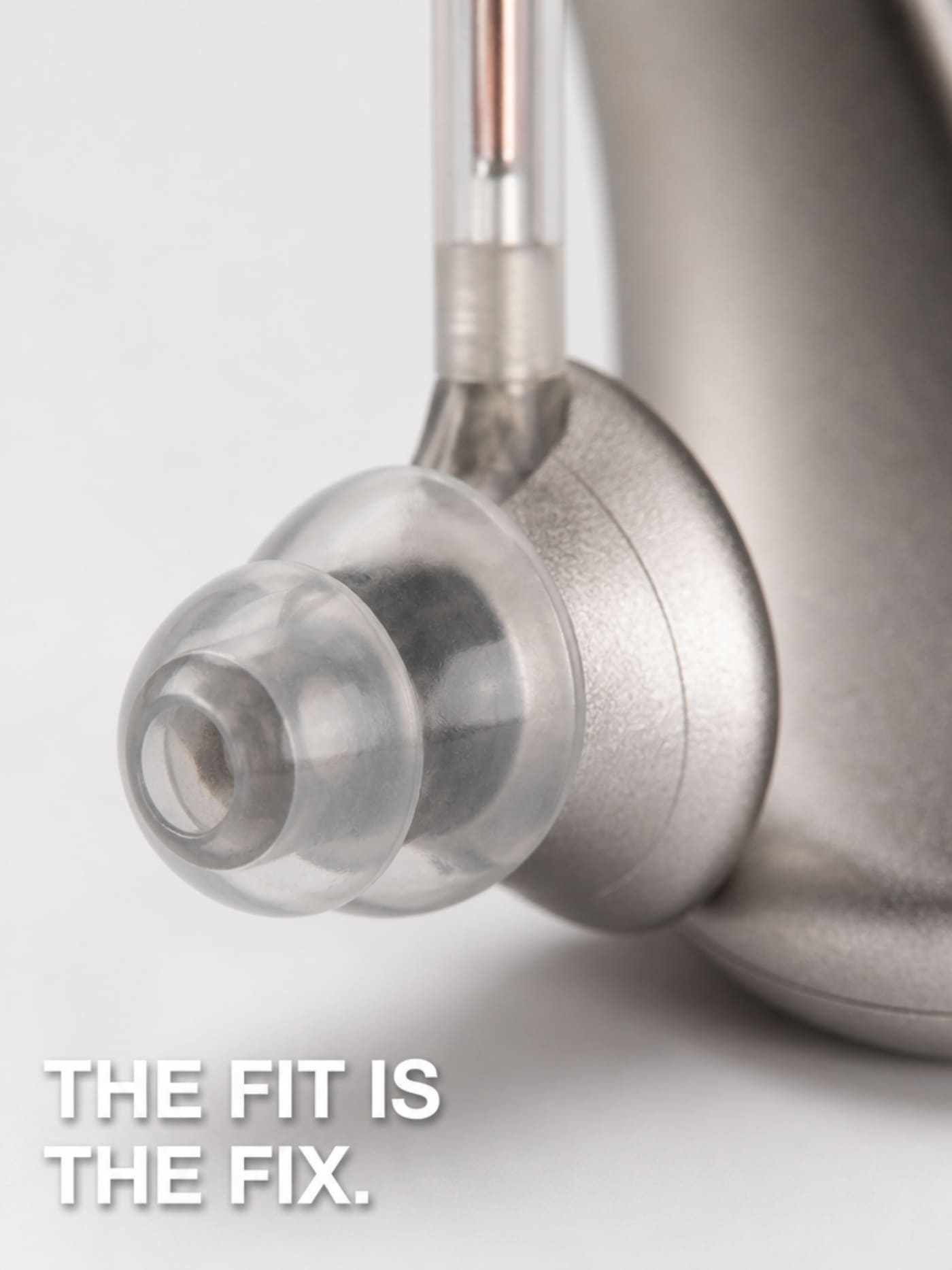 Macro close-up of the Audexa silicone ear-tip dome seated on the BTE receiver tube — the fit is the fix