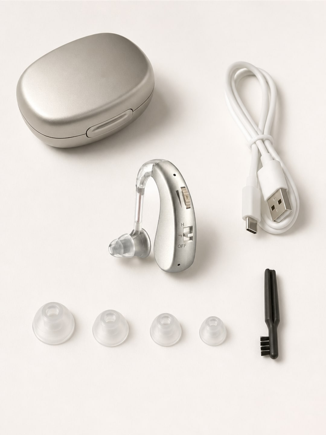 Audexa hearing aids complete flat-lay with four silicone ear-tip sizes, cleaning brush, and USB charging cable