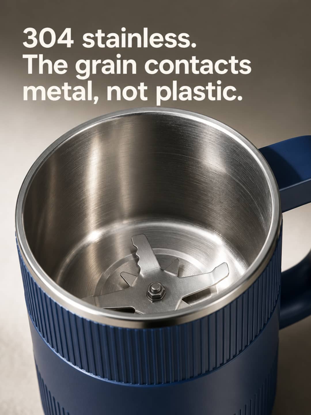 Macro close-up of Grainbloom mill showing 304 stainless steel finish — metal, not plastic, in the grinding contact zone