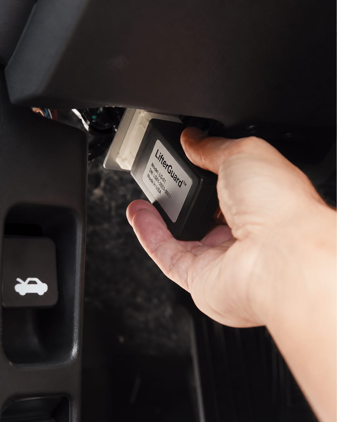 A plug-in OBD-II module being connected in a vehicle