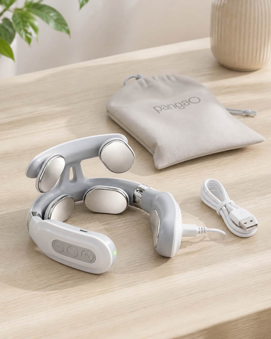 Avenora KnotEase wearable neck device shown on a clean natural surface — the horseshoe-shaped device centered with any included accessories