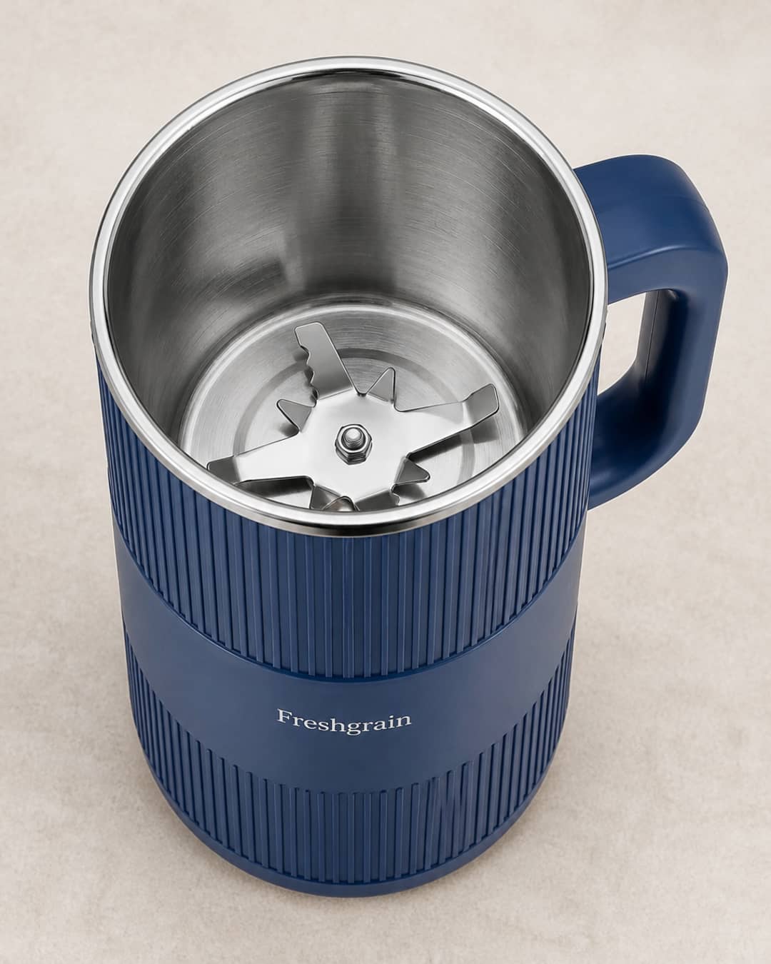 Close-up of GRAIN BLOOM stainless inner milling cup and metal grinding assembly