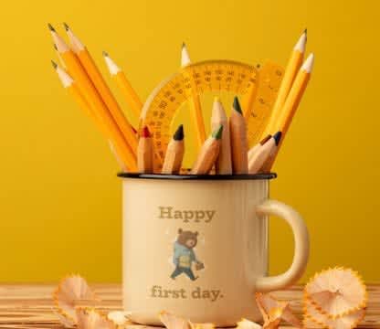 A coffee mug mockup featuring some yellow pencils and a protractor