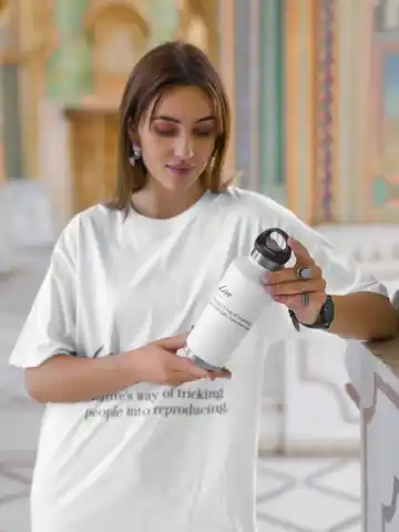 oversized-t-shirt-mockup-of-a-woman-holding-a-travel-mug