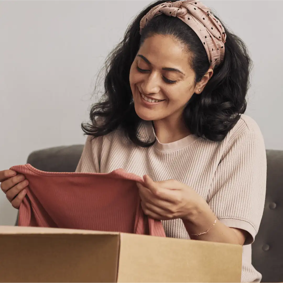 E-Commerce Tools Thumbnail Displaying A Woman Unboxing A T-Shirt