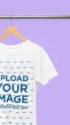 A close-up view of a t-shirt mockup hung on a hanger with a purple background.