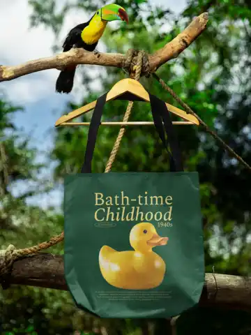Mockup Featuring a Tote Bag Hanging from a Tree Branch with a Toucan