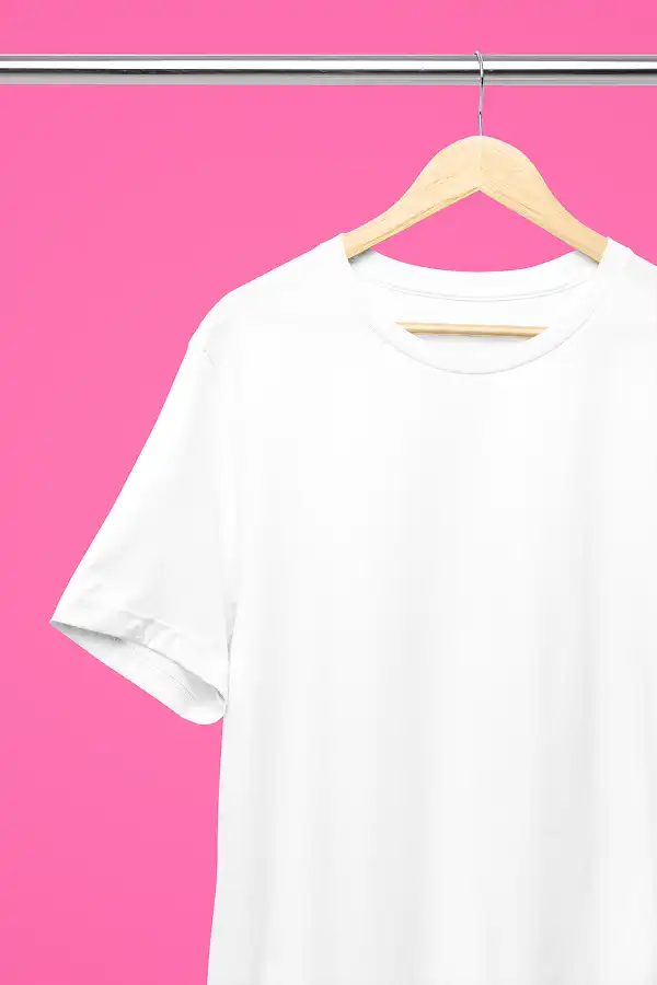 Realistic Mockup of a Bella Canvas 3001 T-Shirt in White Displayed on a Hanger With a Gorgeous Watermelon Pink Background