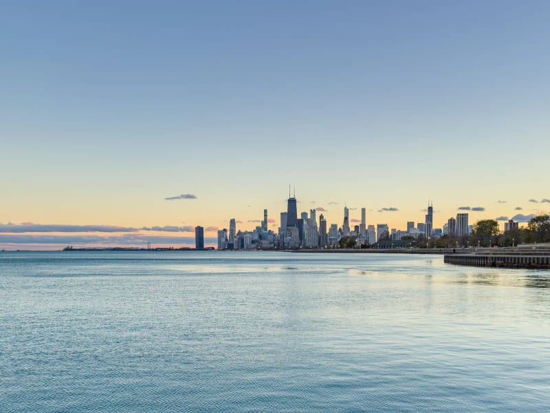 Chicago skyline at dusk across Lake Michigan, seen from the Lakefront Trail on the city's North Side