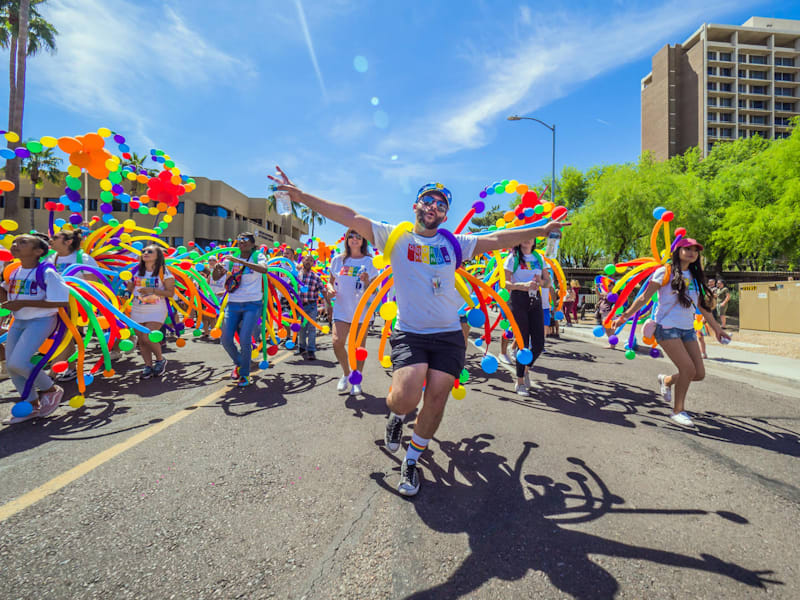 Dancers with rainbow streamers in the Phoenix Pride parade
