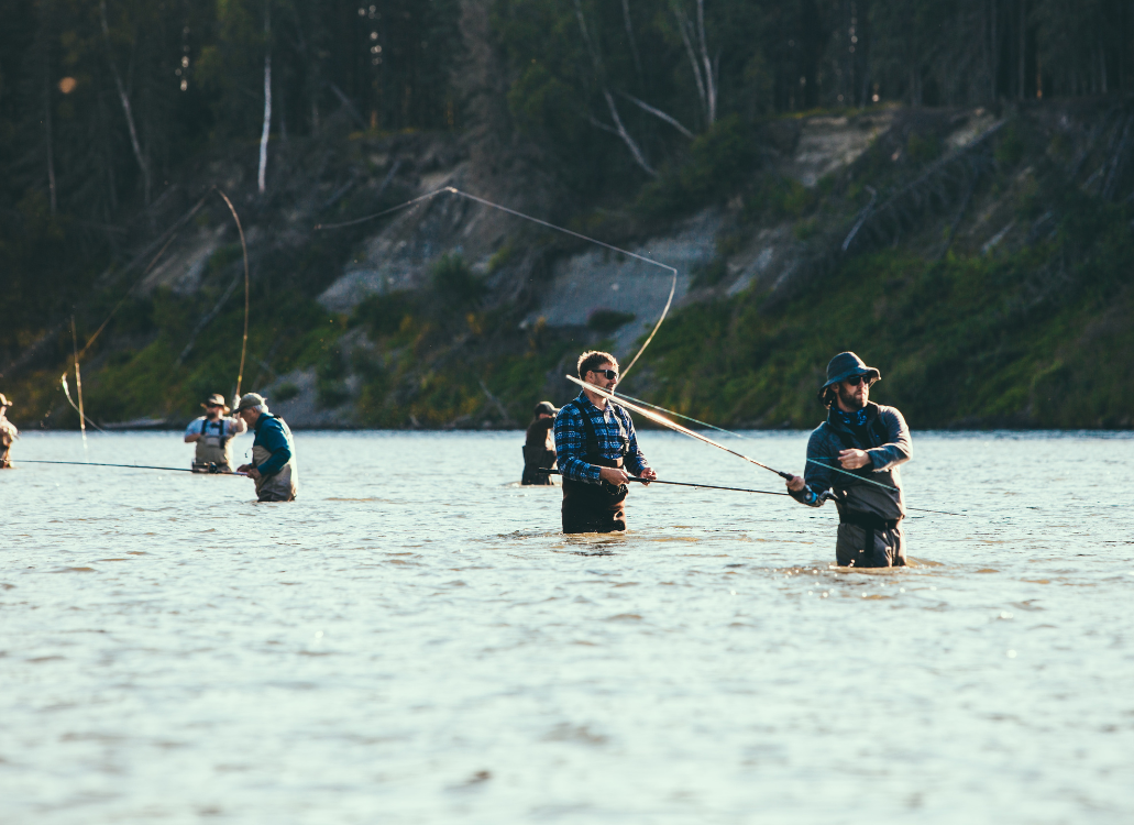 Group of people fly fishing in river