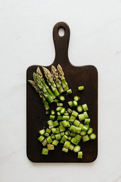 Asparagus cut up on cutting board