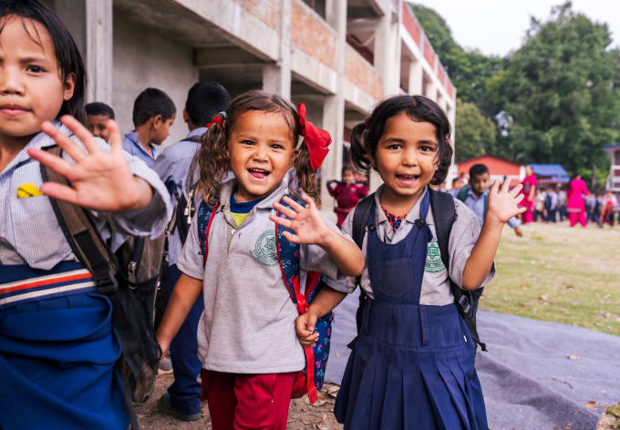 Children waving in the schoolyard