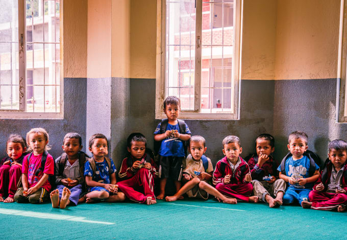 A classroom of young children seated with their teacher