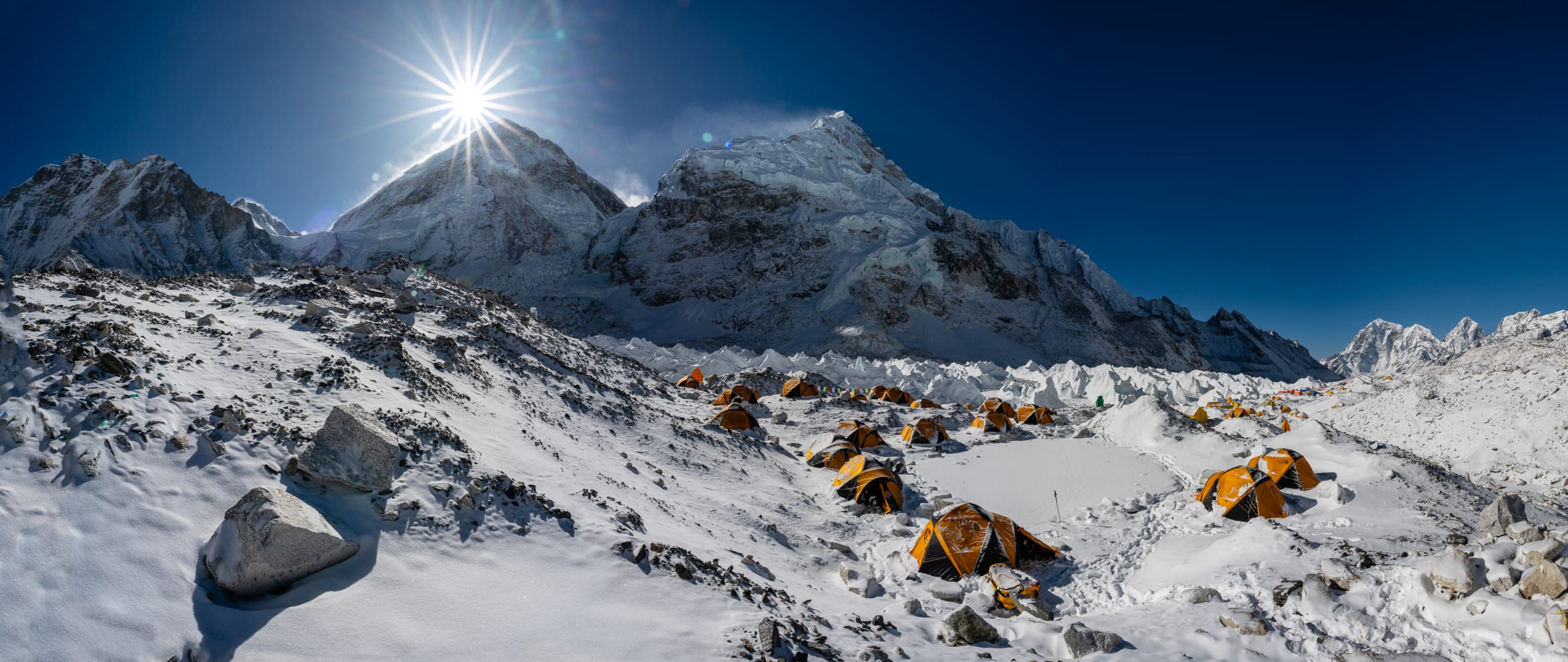 Everest basecamp tents beneath the high peaks at midday