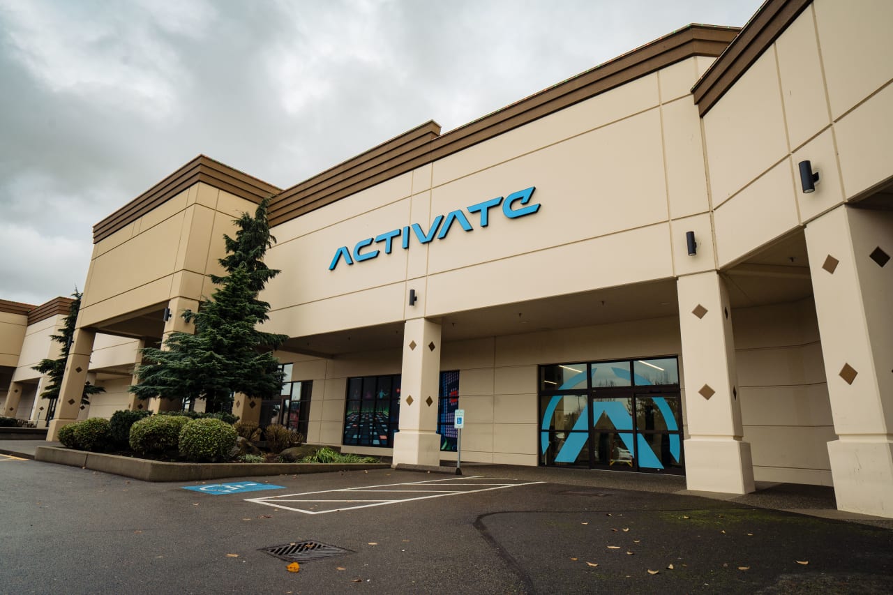 The exterior of Activate Tukwila, with the blue Activate sign above the glass entrance doors.