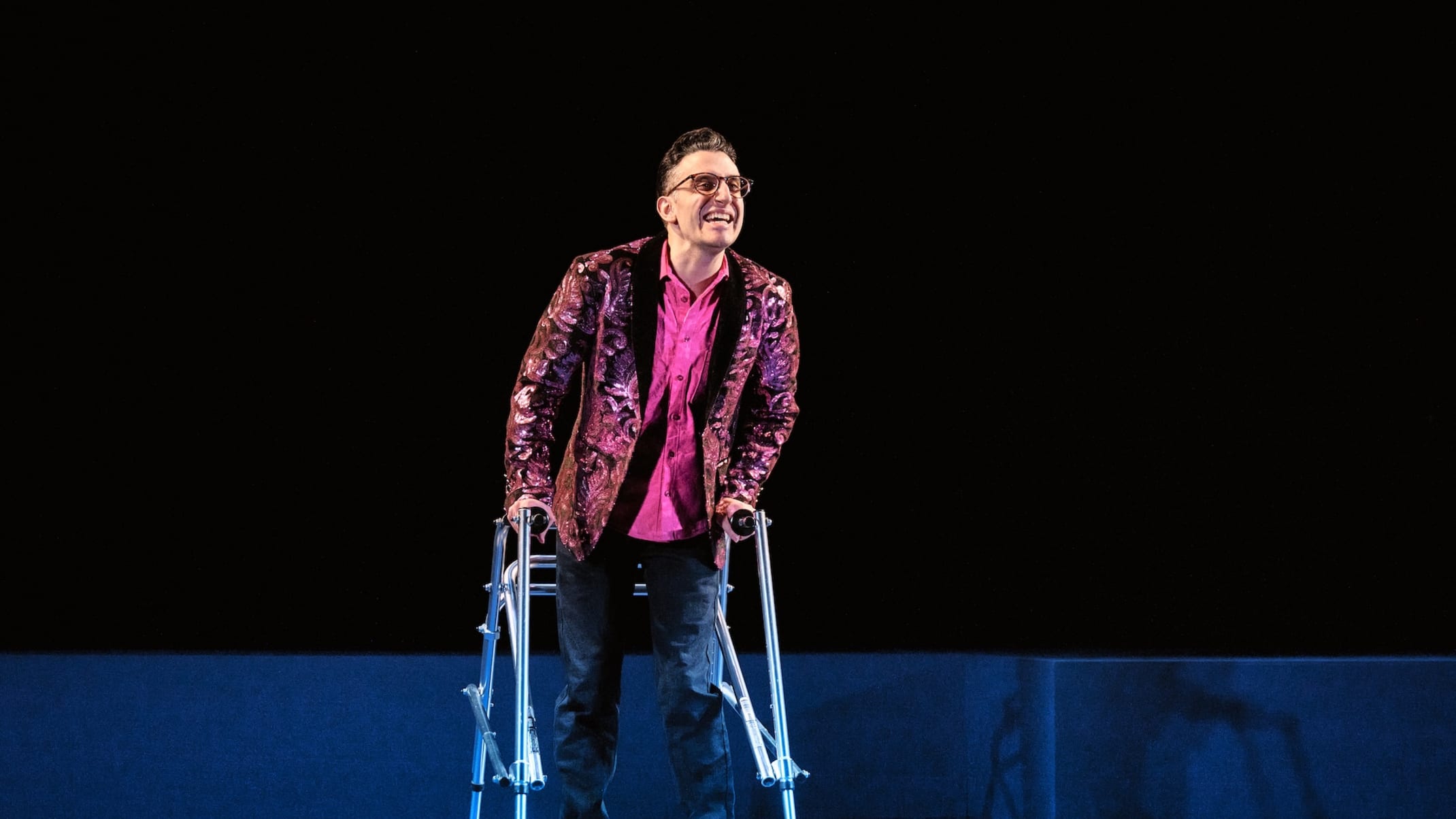 Ryan in a fabulous pink sequined blazer, cast in cool light.