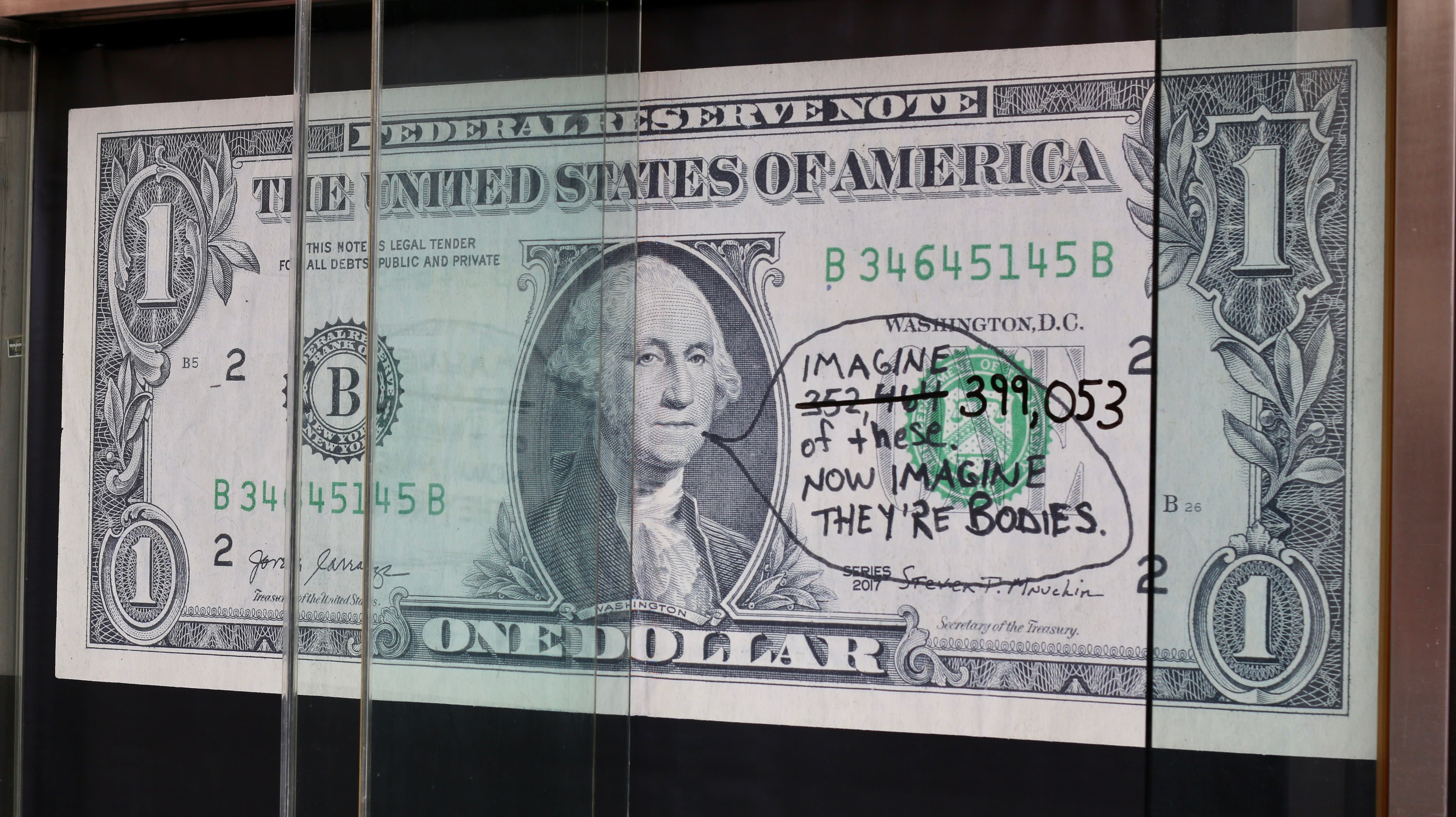 Large rendering of a $1 bill with text. Art by Jilly Ballistic.