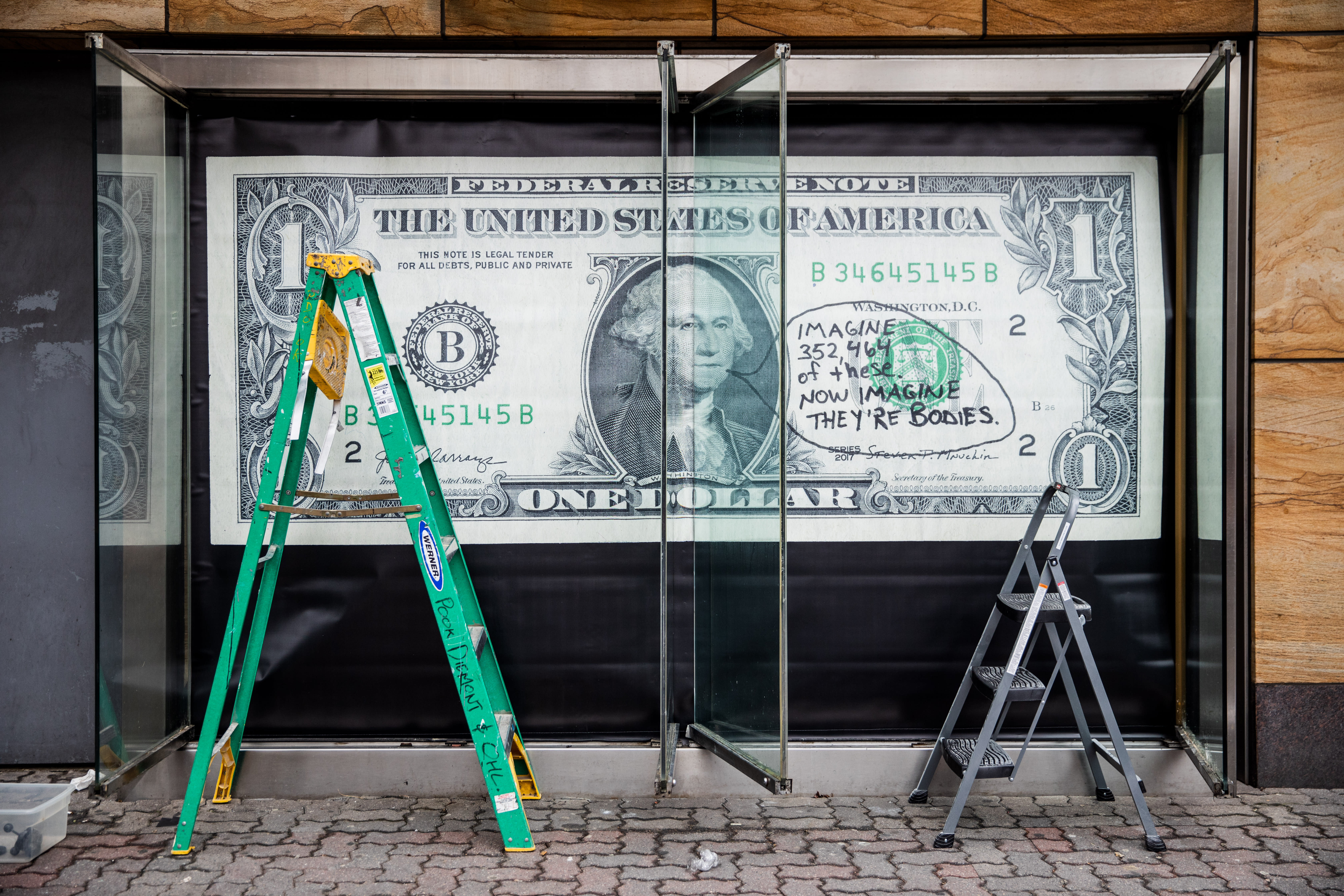 Image of an early 20th century soldier, crouching while wearing a gas mask, is pasted over the right side of an American Eagle ad. On the left side the same ad, a young male model crouches in front of a scenic road on the highway.