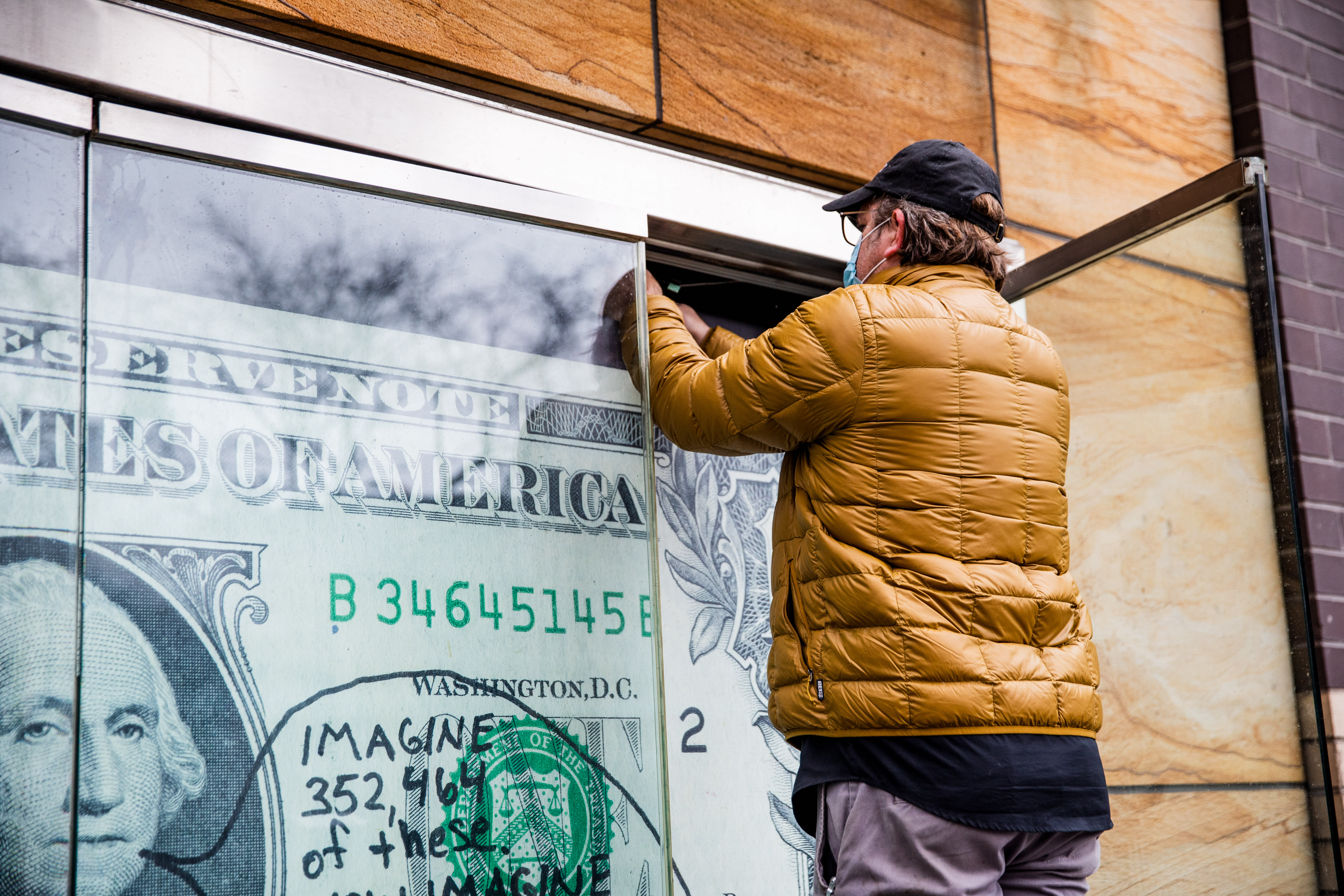 Image of an early 20th century soldier, crouching while wearing a gas mask, is pasted over the right side of an American Eagle ad. On the left side the same ad, a young male model crouches in front of a scenic road on the highway.