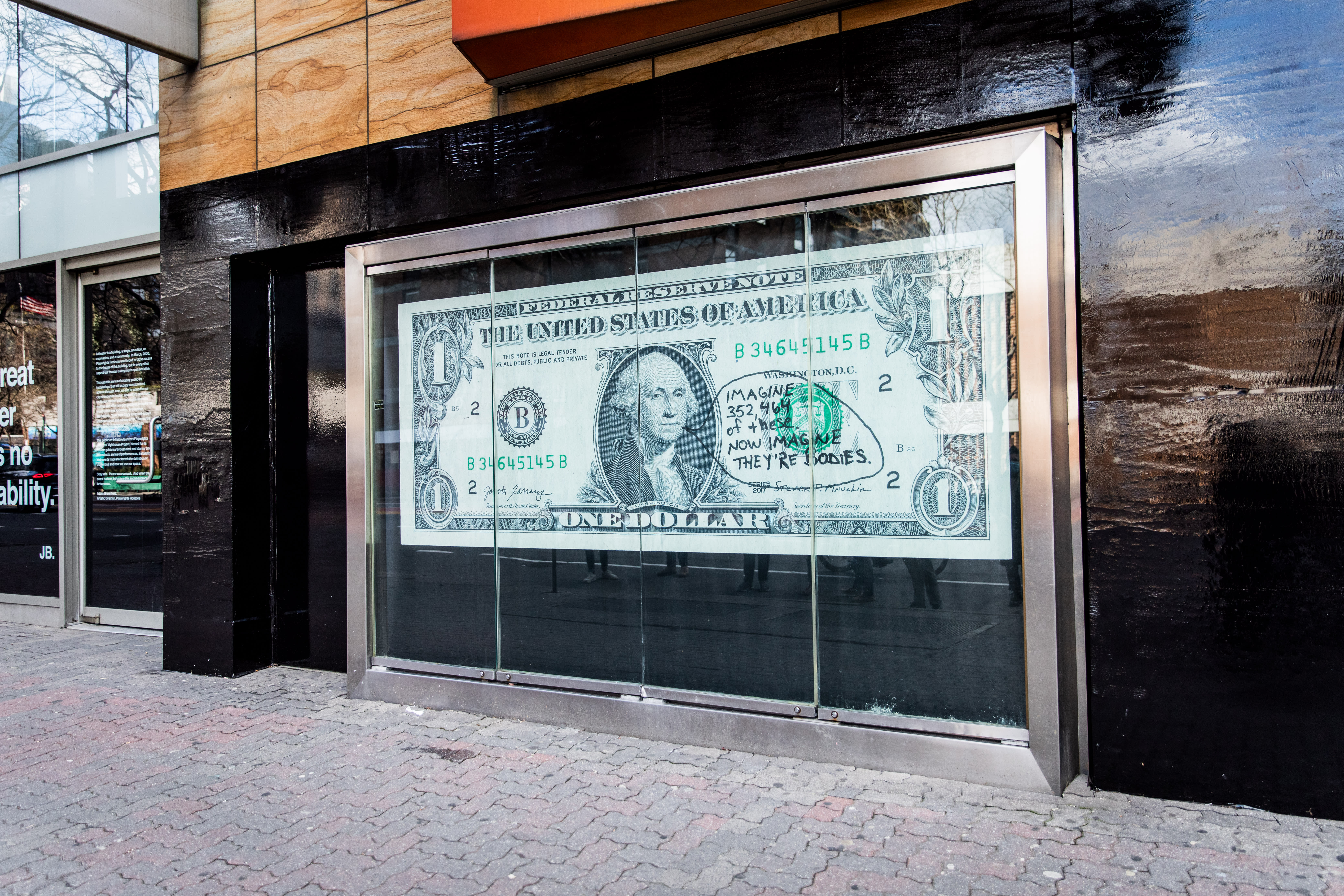 Image of an early 20th century soldier, crouching while wearing a gas mask, is pasted over the right side of an American Eagle ad. On the left side the same ad, a young male model crouches in front of a scenic road on the highway.