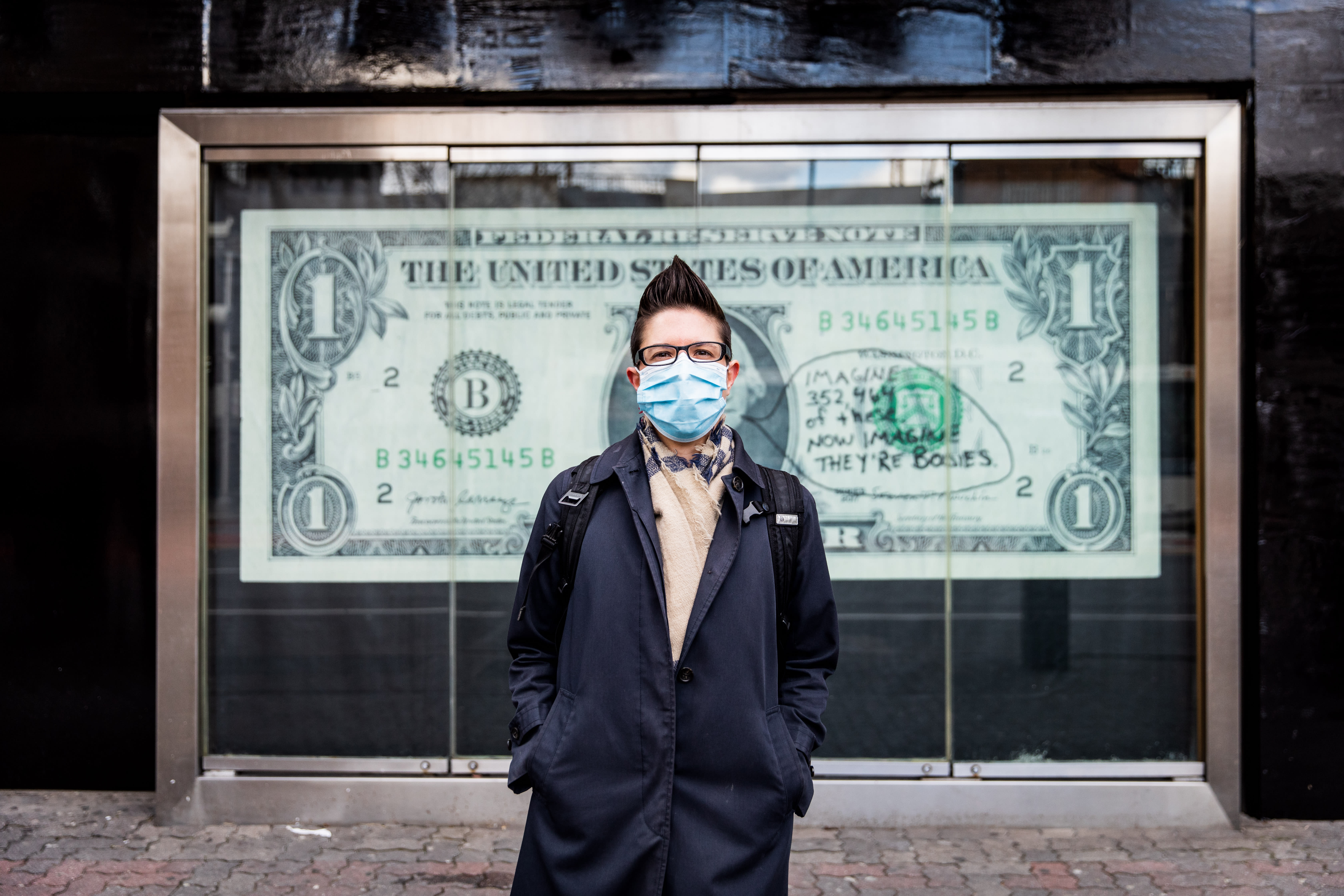 Image of an early 20th century soldier, crouching while wearing a gas mask, is pasted over the right side of an American Eagle ad. On the left side the same ad, a young male model crouches in front of a scenic road on the highway.