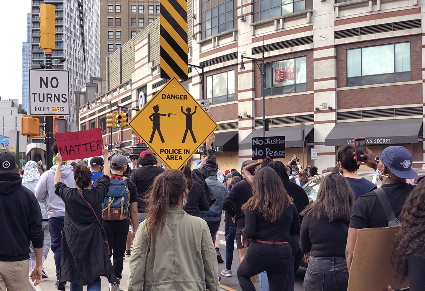 Black and white cutout of dog with gas mask stands on a NYC subway seat