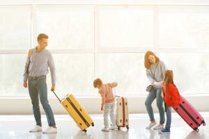 Family on Beach Flying a Kite