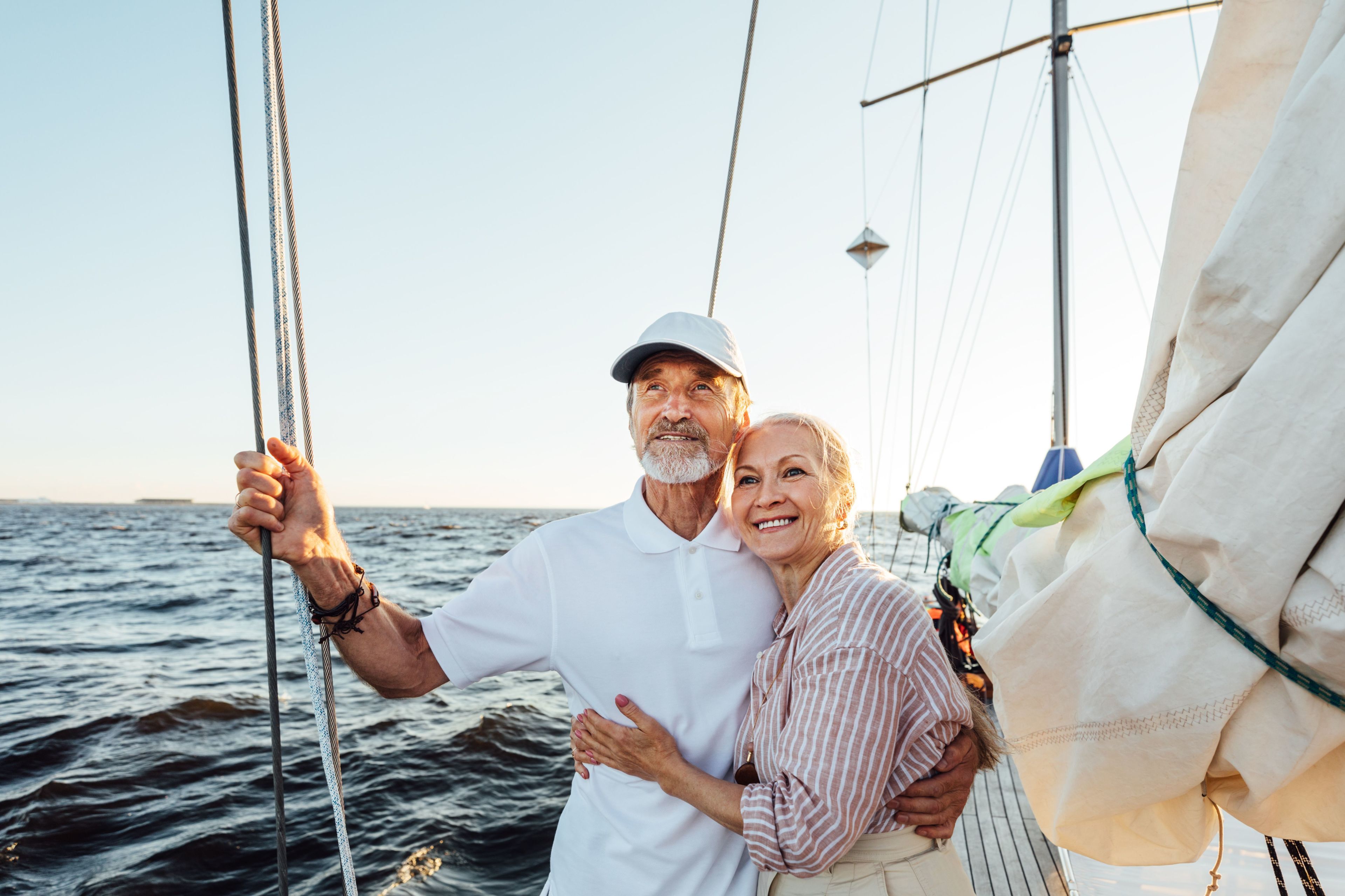 older couple embracing on a sailboat