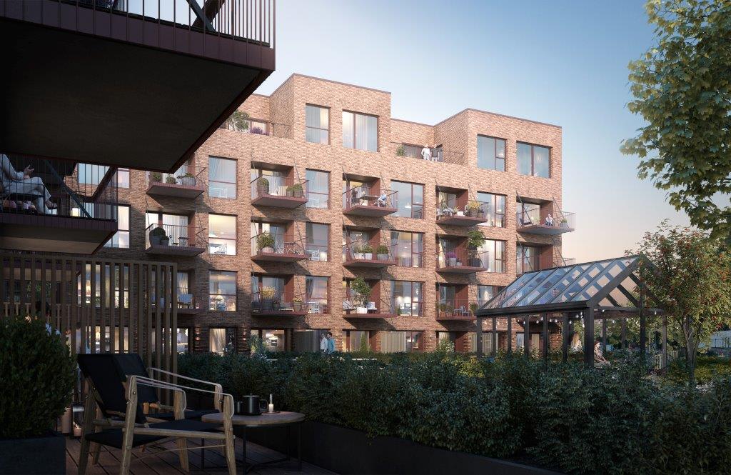 Skogmo Park fellesområde med drivhus og plantekasser sett fra terrasse i hus F