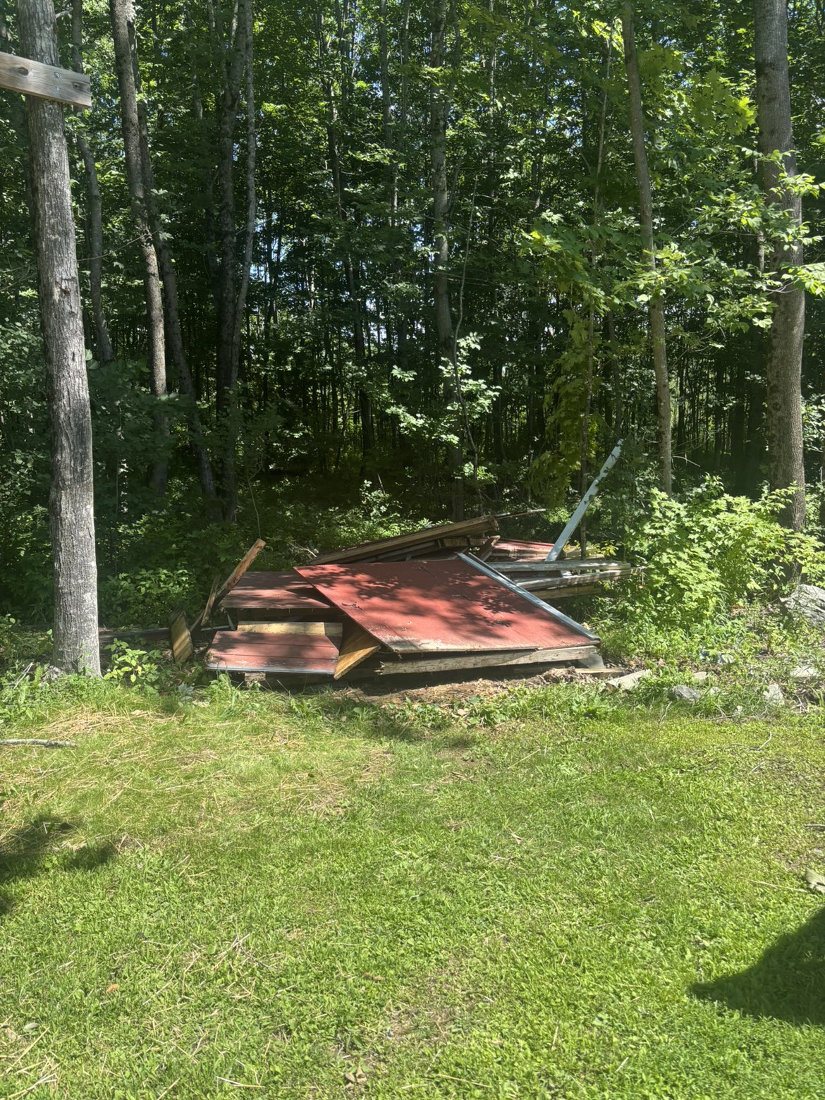 Demolished shed stacked for haul-away