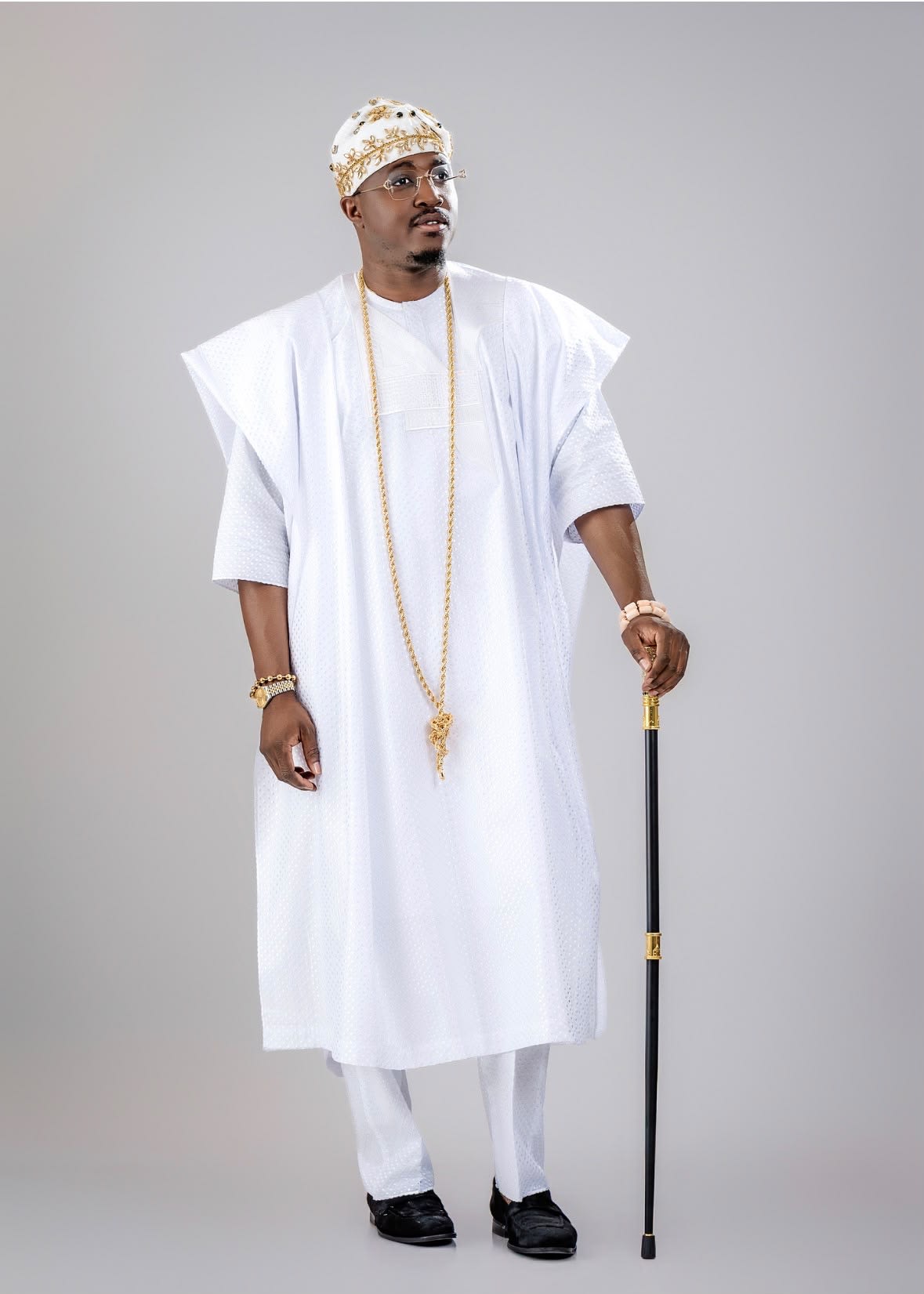 Royal Crown Fila worn with a white agbada, side view