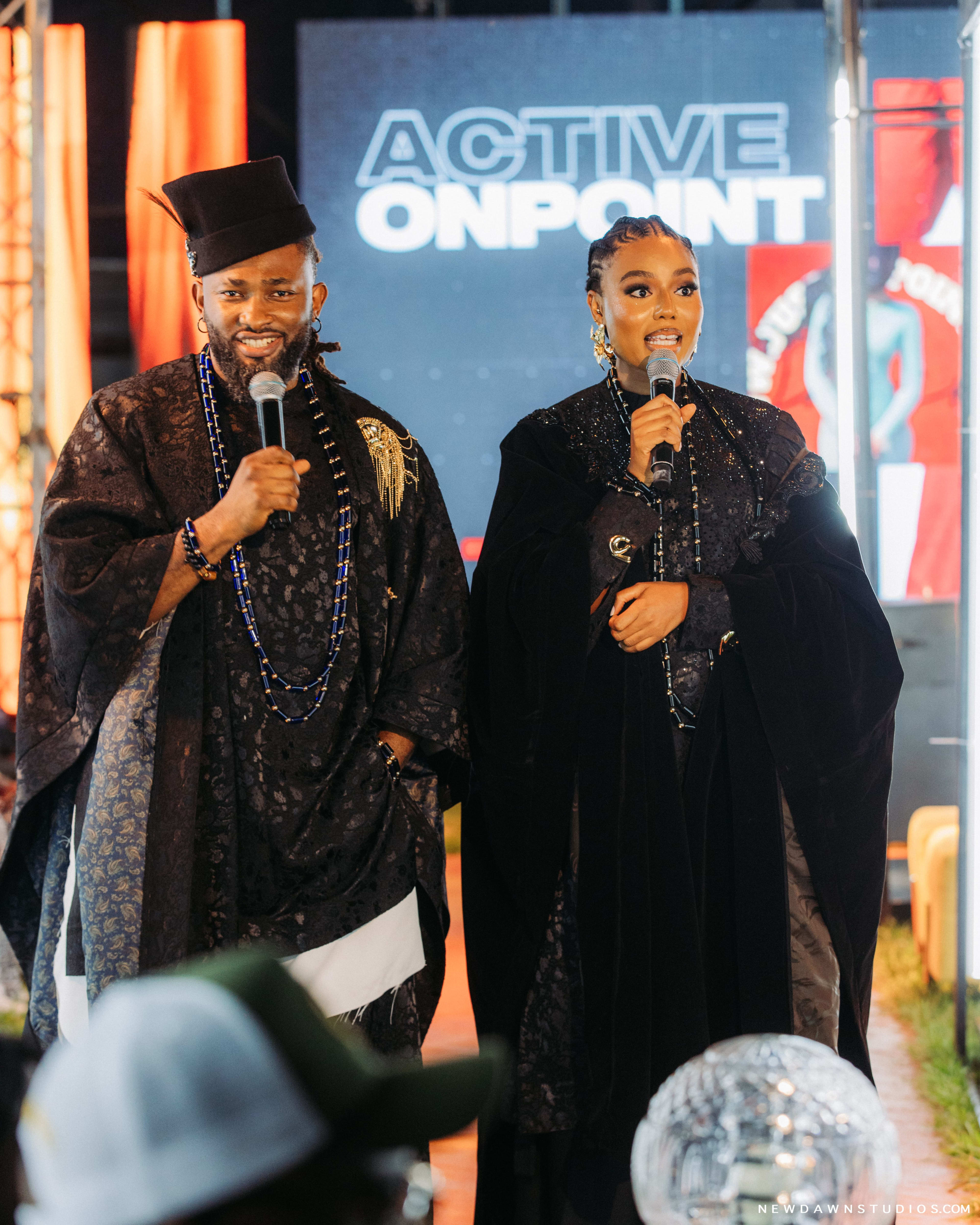 The hosts mid-address together in front of an ACTIVE ONPOINT screen