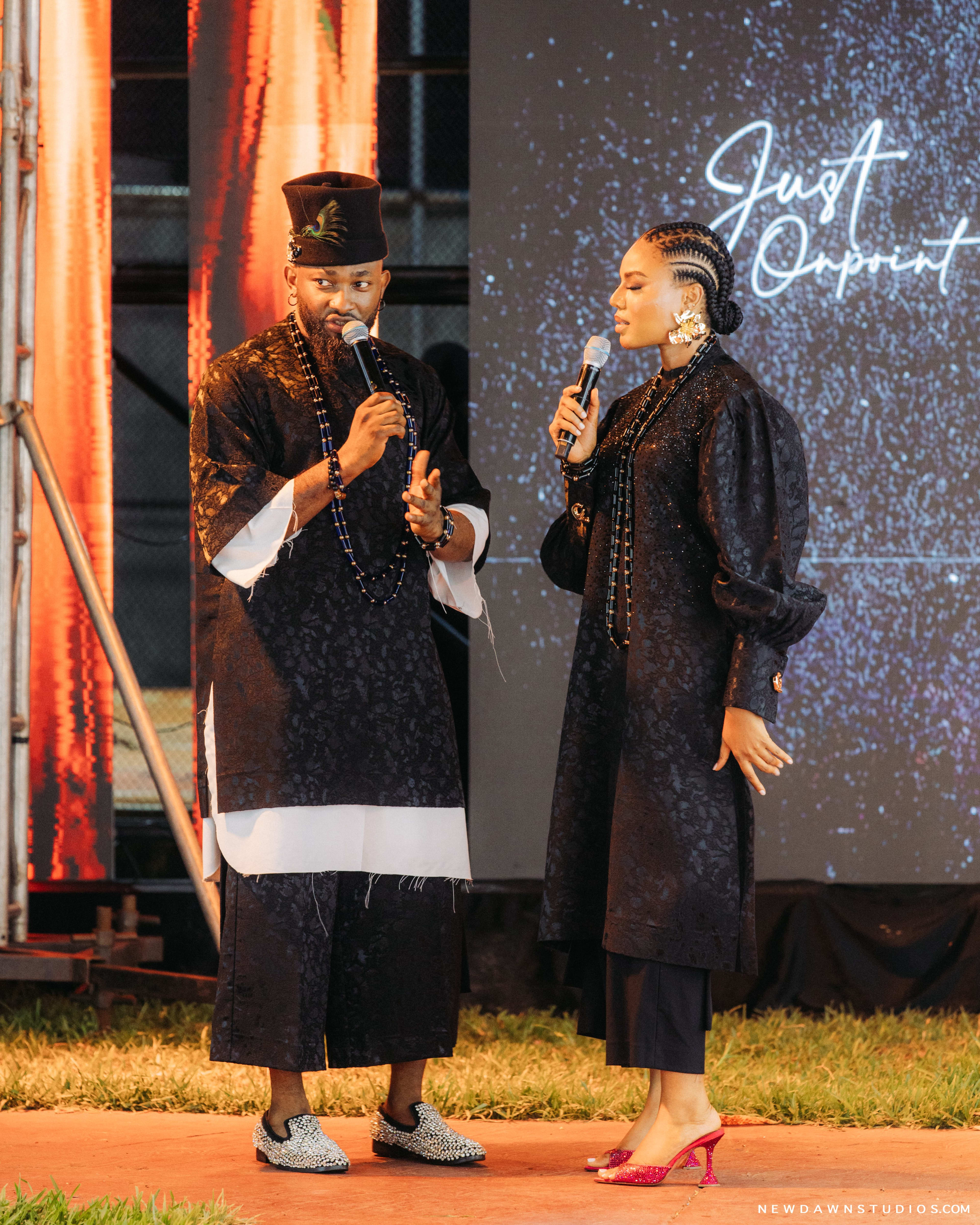 The hosts walking the runway past a "Just Onpoint" script screen amid festive lighting