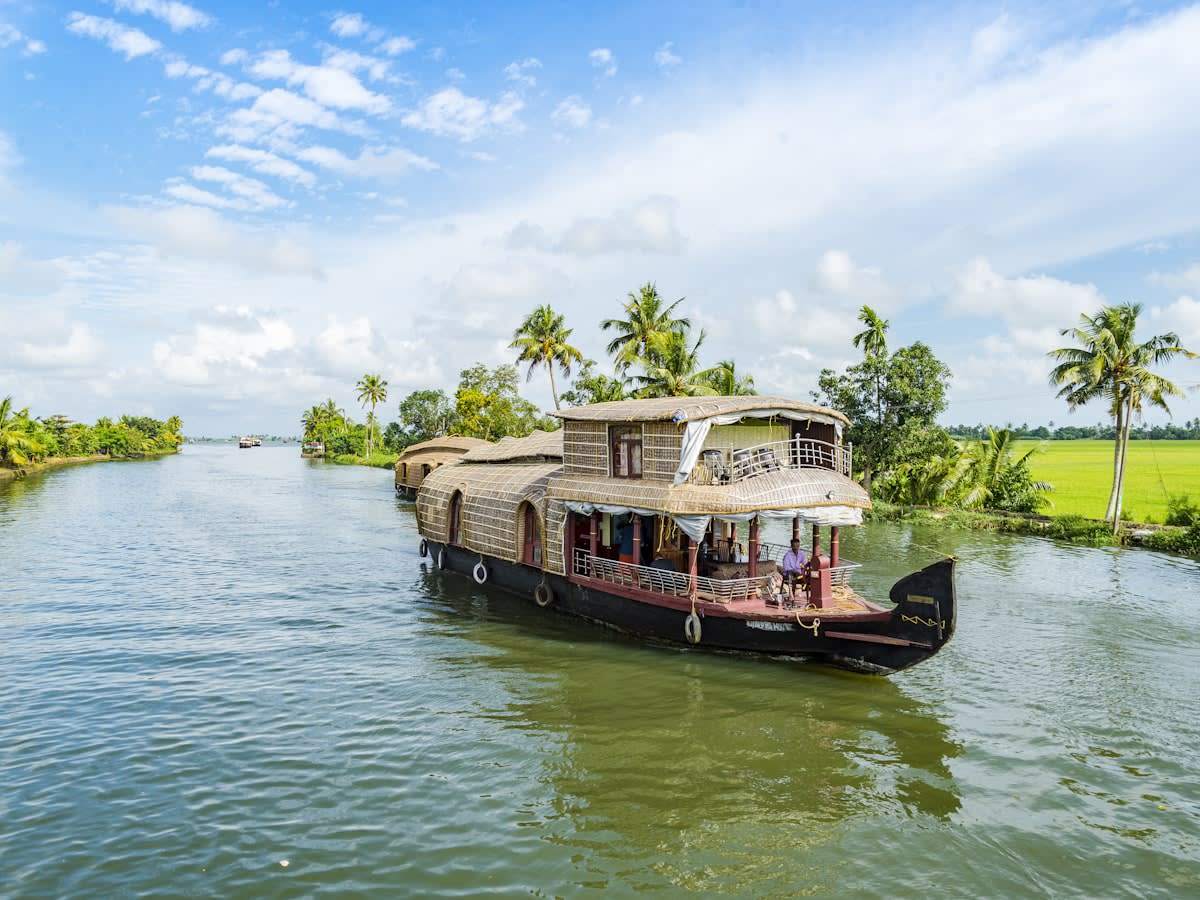 A traditional Kerala houseboat moored on the palm-lined backwaters at Alappuzha