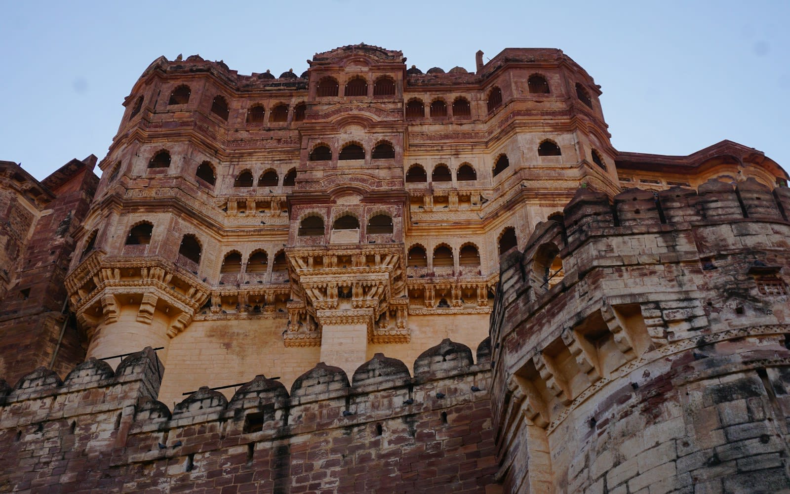 The carved palace facade of Mehrangarh Fort seen from below