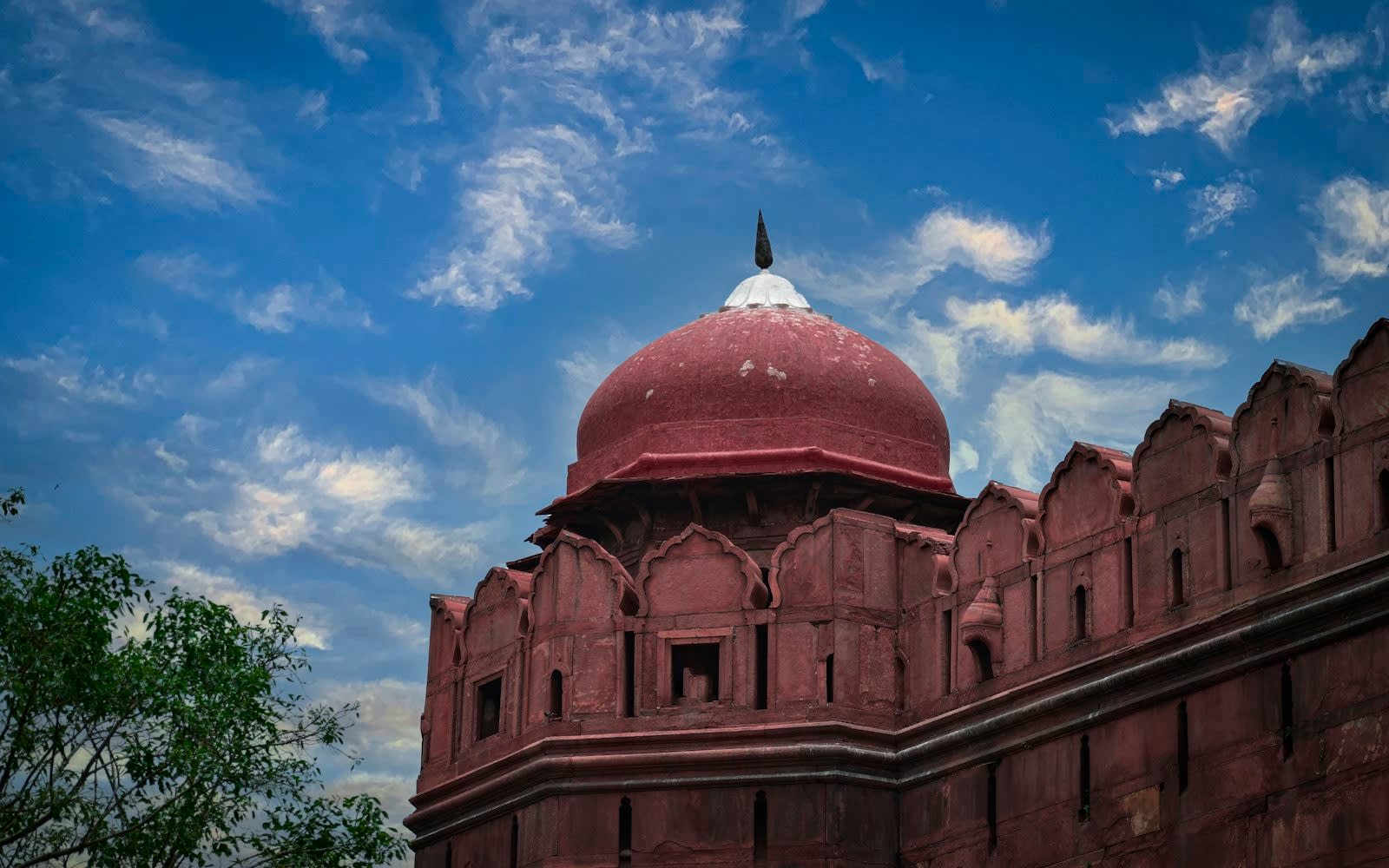 A domed pavilion above the red sandstone wall of the fort