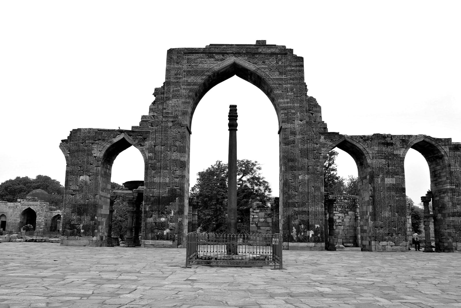 The Iron Pillar of Delhi framed by a ruined arch of the Quwwat-ul-Islam mosque