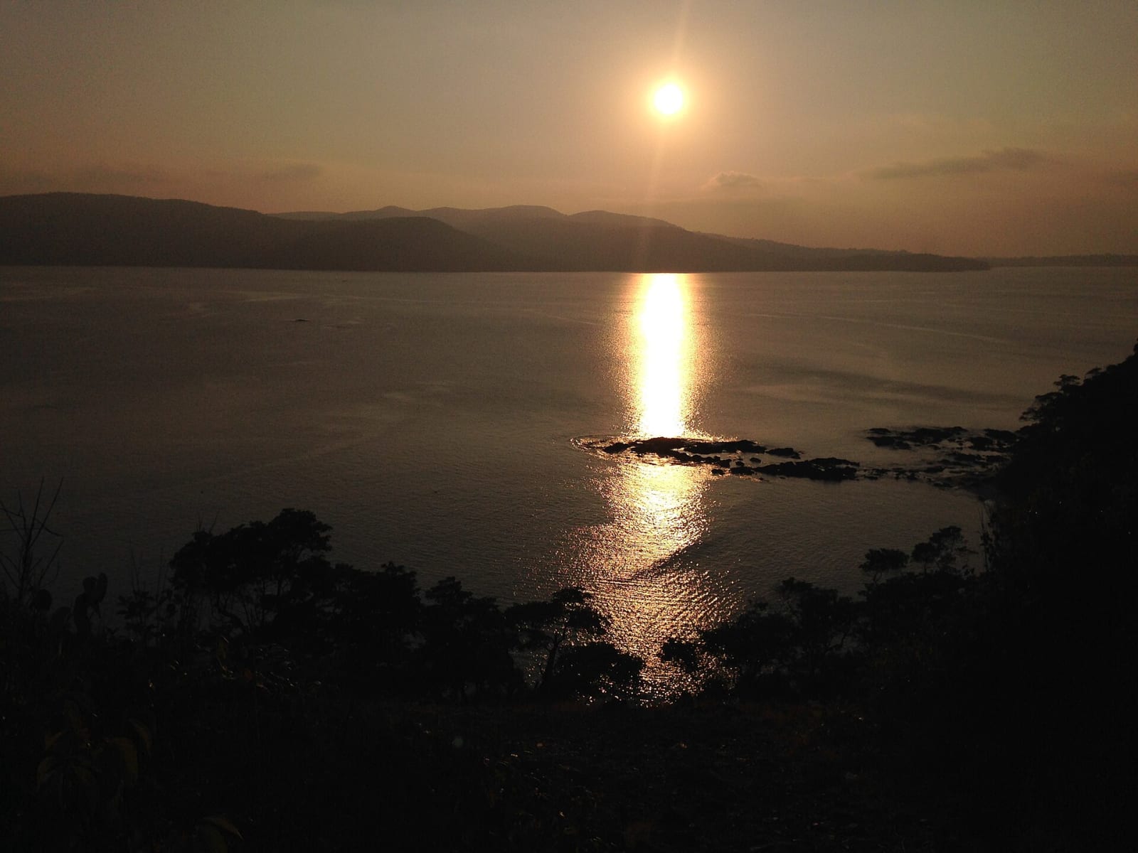 The setting sun reflecting on the sea beyond the Munda Pahad coast, Chidiya Tapu