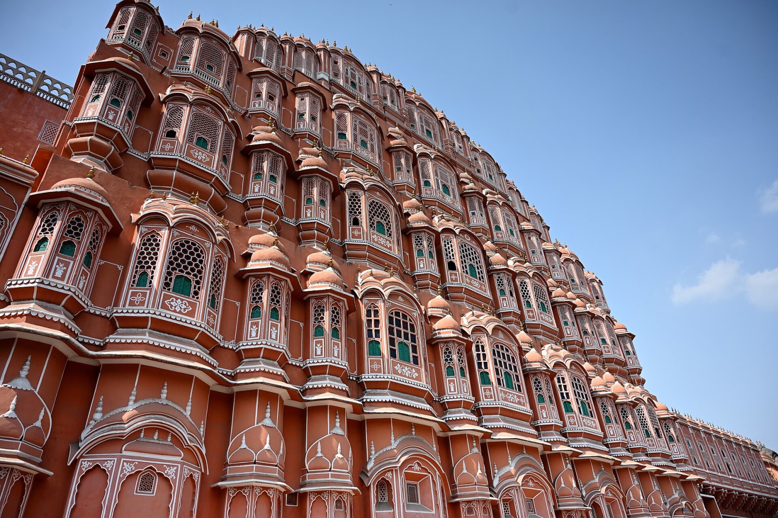 Rows of jharokha windows and small domed canopies on the Hawa Mahal facade