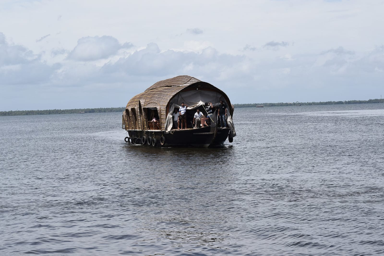 A houseboat on the open water of Vembanad Lake, Kerala