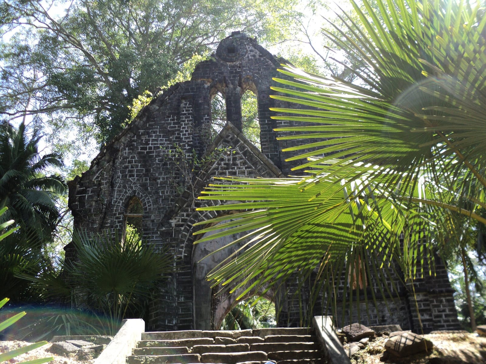 The ruined stone church on Ross Island, Andaman, with palm fronds in front