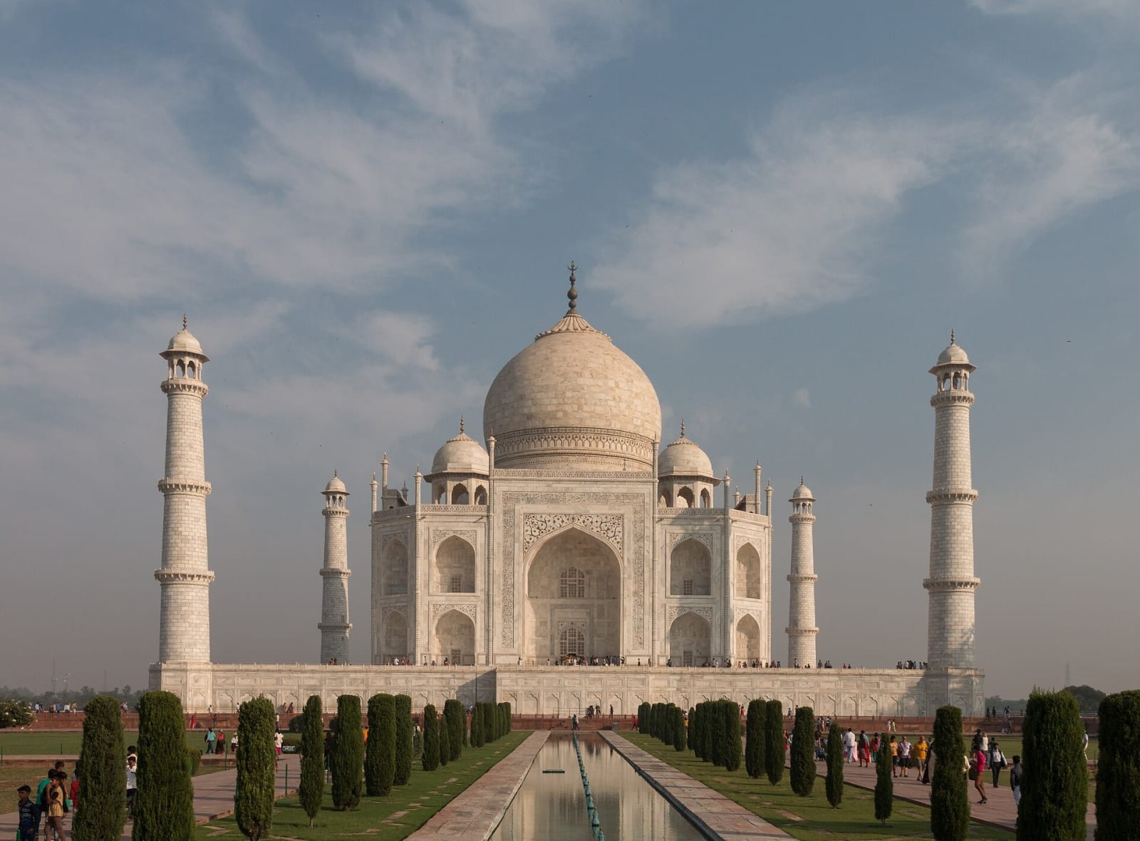 The Taj Mahal and its garden seen from an angle across the lawns in soft light