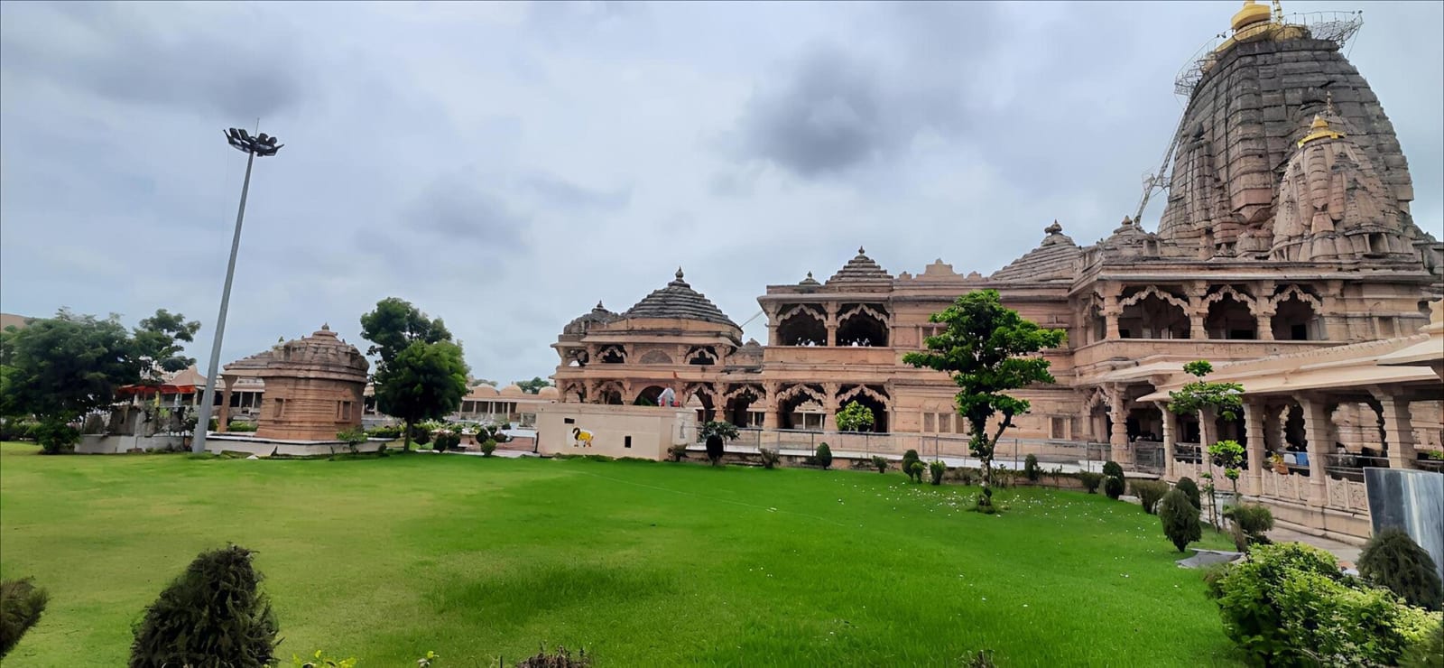 Pink stone Sawariya Seth temple at Mandphiya, Rajasthan, with a lawn in front