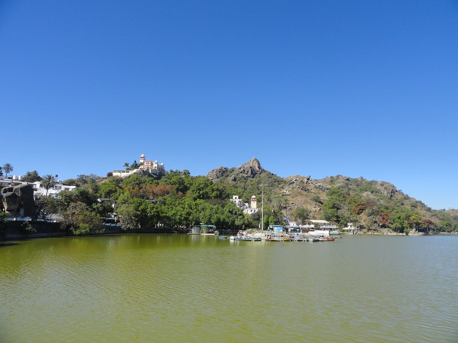 Nakki Lake at Mount Abu with boats at the shore and forested hills behind