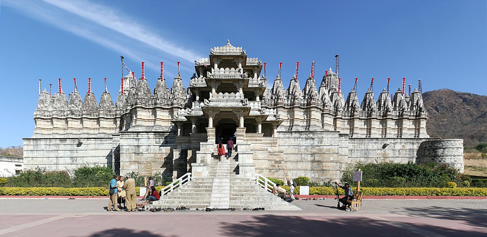 White marble Ranakpur Jain temple with its many spires and a wide stone stairway